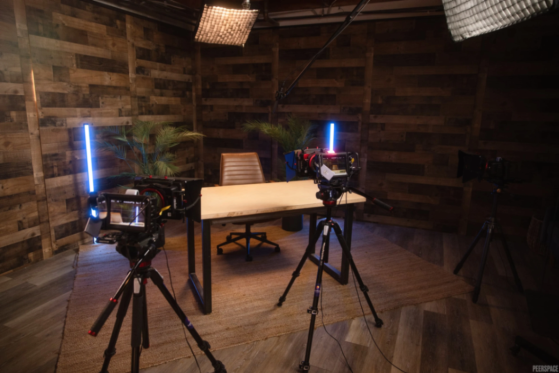 Camera rigs around a wood-clad podcast set